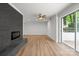 Spacious living room with hardwood floors, decorative fireplace, and sliding glass doors to the patio at 218 Kingsway Cir, Charlotte, NC 28214