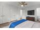 Staged main bedroom with ceiling fan, wood-look floors and closet at 218 Kingsway Cir, Charlotte, NC 28214