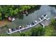 Aerial view showcasing multiple boat slips docked on lake with lush trees at 26056 Neptunes Lndg, Fort Mill, SC 29708