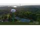 Tega Cay offers scenic views of lush greenery, tennis courts, and a water tower in a vibrant community setting at 26056 Neptunes Lndg, Fort Mill, SC 29708
