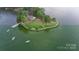 Aerial view of a lakefront with a grassy community area at 26056 Neptunes Lndg, Fort Mill, SC 29708