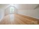 This attic space features bamboo flooring, arched window, and lighting at 26056 Neptunes Lndg, Fort Mill, SC 29708