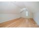 This attic space features bamboo flooring, an attic window, and modern ceiling light at 26056 Neptunes Lndg, Fort Mill, SC 29708