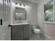 This bathroom has a gray vanity, herringbone tile floor, and a window for natural light at 26056 Neptunes Lndg, Fort Mill, SC 29708