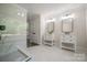 Modern bathroom boasts double vanity sinks, marble floors, and glass shower at 26056 Neptunes Lndg, Fort Mill, SC 29708