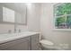 Bathroom features a vanity and mirror with a window offering natural light at 26056 Neptunes Lndg, Fort Mill, SC 29708