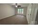 Bedroom featuring neutral carpet, ceiling fan, and window providing natural light at 26056 Neptunes Lndg, Fort Mill, SC 29708