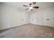 Bedroom featuring neutral carpet, a ceiling fan, and multiple closets at 26056 Neptunes Lndg, Fort Mill, SC 29708