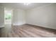 Spacious bedroom with light wood floors, trim, and access to the bathroom at 26056 Neptunes Lndg, Fort Mill, SC 29708