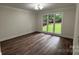 Spacious bedroom with large windows overlooking a lush green lawn and wood-look floors at 26056 Neptunes Lndg, Fort Mill, SC 29708