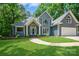 Charming exterior elevation with manicured lawn, arched windows, and inviting entrance at 26056 Neptunes Lndg, Fort Mill, SC 29708