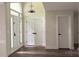 Welcoming foyer featuring multiple doors, modern lighting, and wood grain vinyl floors at 26056 Neptunes Lndg, Fort Mill, SC 29708
