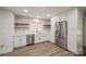 This open kitchen features white cabinets, stainless steel appliances and wood shelving at 26056 Neptunes Lndg, Fort Mill, SC 29708