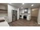 Modern kitchen with white cabinets, stainless steel refrigerator, and wood grain vinyl floors at 26056 Neptunes Lndg, Fort Mill, SC 29708