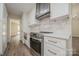 This updated kitchen features stainless steel appliances, white cabinets and light countertops at 26056 Neptunes Lndg, Fort Mill, SC 29708