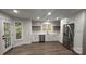 Bright, updated kitchen with white cabinets, stainless steel appliances, and wood grain vinyl floors at 26056 Neptunes Lndg, Fort Mill, SC 29708