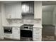 Updated kitchen featuring stainless steel range, microwave and vent hood and wood grain vinyl flooring at 26056 Neptunes Lndg, Fort Mill, SC 29708