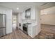 Updated kitchen features stainless steel appliances, white cabinets and quartz countertops at 26056 Neptunes Lndg, Fort Mill, SC 29708