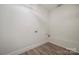 Functional laundry room with vinyl flooring, utility connections, and freshly painted walls at 26056 Neptunes Lndg, Fort Mill, SC 29708