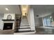 Elegant staircase in living room with fireplace and wood grain vinyl floors at 26056 Neptunes Lndg, Fort Mill, SC 29708
