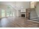 Spacious living room featuring a fireplace, hardwood floors, and staircase at 26056 Neptunes Lndg, Fort Mill, SC 29708