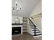 Stylish living room with fireplace, built-in shelving, staircase, wood grain vinyl floors and chandelier at 26056 Neptunes Lndg, Fort Mill, SC 29708