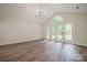 Open living room with hardwood floors and a view of the outdoors through French doors at 26056 Neptunes Lndg, Fort Mill, SC 29708
