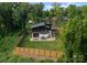 Aerial view of a modern home with a fenced backyard, lush landscaping, and mature trees at 2913 Lake Ave, Charlotte, NC 28208