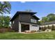 A modern home with an inviting backyard, outdoor seating, and a beautiful green lawn at 2913 Lake Ave, Charlotte, NC 28208