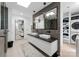 Bright, modern bathroom with double sinks, floating vanity, and laundry area at 2913 Lake Ave, Charlotte, NC 28208