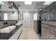 Well-lit bathroom with double sinks, a glass shower, and modern design at 2913 Lake Ave, Charlotte, NC 28208