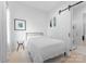 Clean and serene bedroom with minimalist decor, featuring a comfortable bed and ample natural light at 2913 Lake Ave, Charlotte, NC 28208