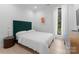 Bright bedroom with a green headboard and light hardwood floors at 2913 Lake Ave, Charlotte, NC 28208