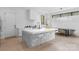 Modern kitchen with sleek white countertops, a large island, and stainless steel appliances at 2913 Lake Ave, Charlotte, NC 28208
