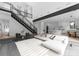 Spacious living area with modern staircase, sleek finishes, and open layout connecting living room and kitchen at 2913 Lake Ave, Charlotte, NC 28208