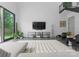 Stylish living room featuring large windows, a modern entertainment center, and comfortable seating at 2913 Lake Ave, Charlotte, NC 28208