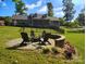 Backyard with a stone fire pit and seating area, perfect for entertaining at 322 Killian Rd, Stanley, NC 28164