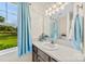 Bright bathroom with vanity, large window, and views of the lush exterior at 322 Killian Rd, Stanley, NC 28164