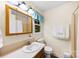 Bright bathroom featuring a vanity, medicine cabinet, toilet, and shower at 322 Killian Rd, Stanley, NC 28164