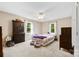 Spacious bedroom with neutral carpet, ceiling fan, and two windows at 322 Killian Rd, Stanley, NC 28164