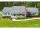 Charming home featuring a cozy front porch, lush landscaping, and a well-maintained lawn at 322 Killian Rd, Stanley, NC 28164