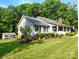 Inviting front of the house with a covered porch and manicured landscaping at 322 Killian Rd, Stanley, NC 28164
