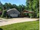 Detached garage with a carport situated on a spacious lot at 322 Killian Rd, Stanley, NC 28164