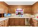 Well-equipped kitchen boasting ample counter space, wood cabinetry, and a cozy window with natural light at 322 Killian Rd, Stanley, NC 28164