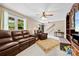 Comfortable living room featuring leather furniture, a neutral color palette, and ample natural light at 322 Killian Rd, Stanley, NC 28164