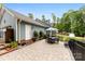 Inviting outdoor patio featuring a dining area, lush greenery, and stylish patio furniture at 322 Killian Rd, Stanley, NC 28164