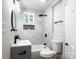 Modern bathroom featuring tiled walls, stylish fixtures, walk-in shower, and ample natural light at 330 17Th Nw St, Hickory, NC 28601