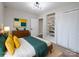 Bright bedroom with a neutral color palette, wood floors, built-in shelving and a spacious closet at 330 17Th Nw St, Hickory, NC 28601