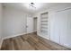 Bright bedroom with a neutral color palette, wood floors, built-in shelving and a spacious closet at 330 17Th Nw St, Hickory, NC 28601