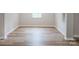 Empty room showcasing luxury vinyl flooring, neutral walls, and natural light from the window at 330 17Th Nw St, Hickory, NC 28601
